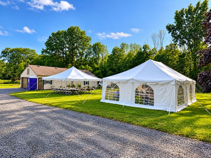 A 20 by 20 tent and a 20 by 30 tent with window sidewalls set up side by side